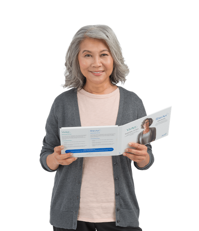 Woman looking at a RhinAer informational packet