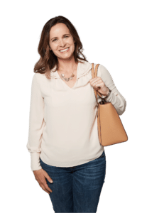 Smiling woman standing while holding her purse